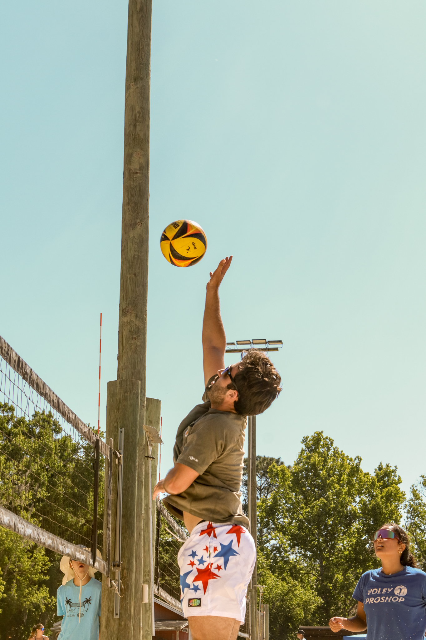 Volleyball player jumping to hit ball during tournament